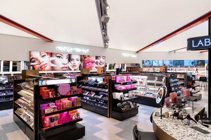 The interior of the Mecca beauty and makeup store, with shelves of makeup products.
